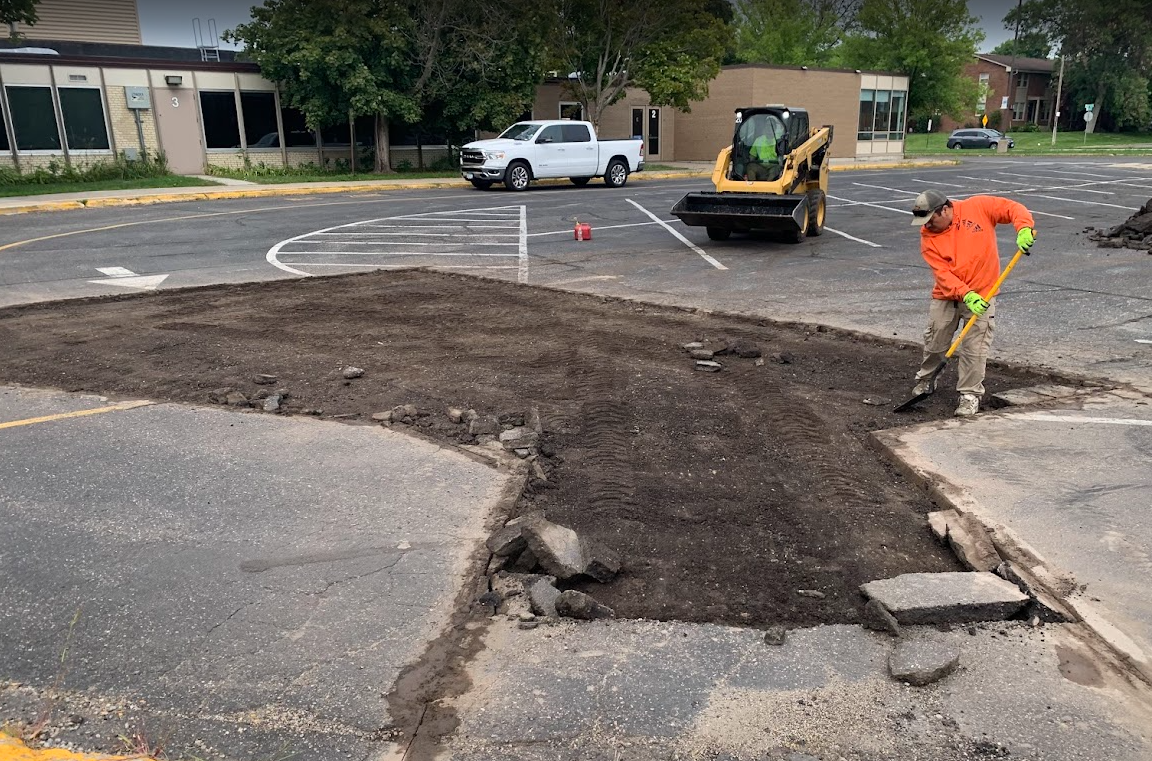 An empty parking lot in front of a shopping center