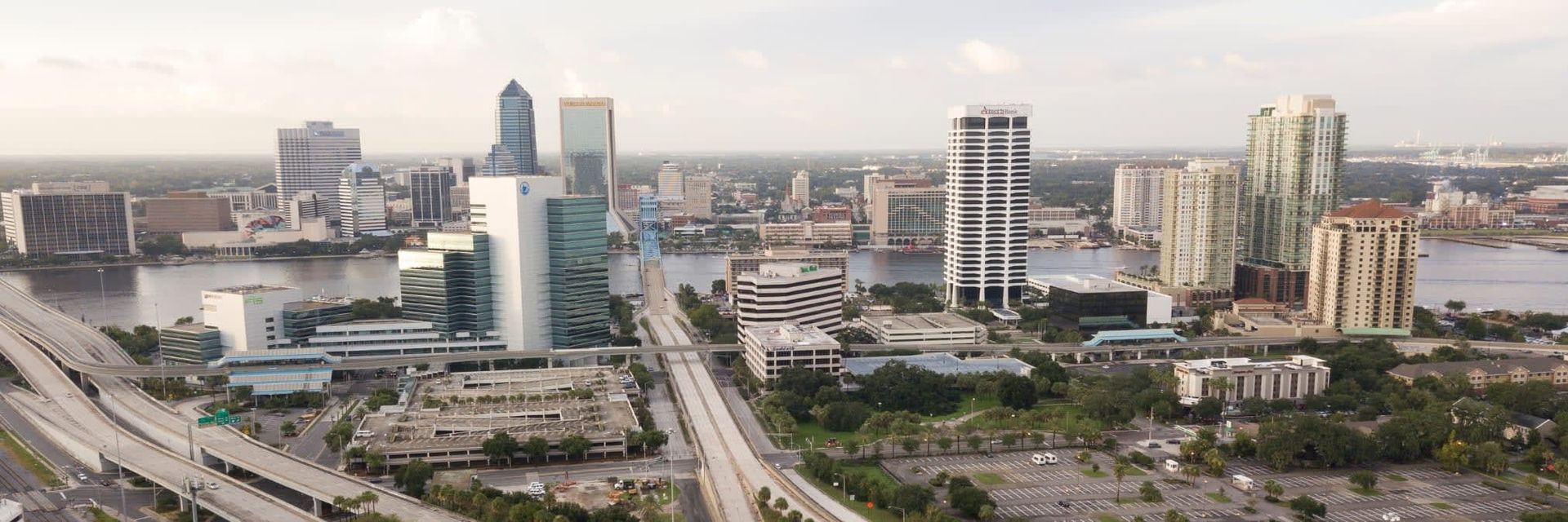 Aerial view of a city skyline with several tall buildings along a body of water.