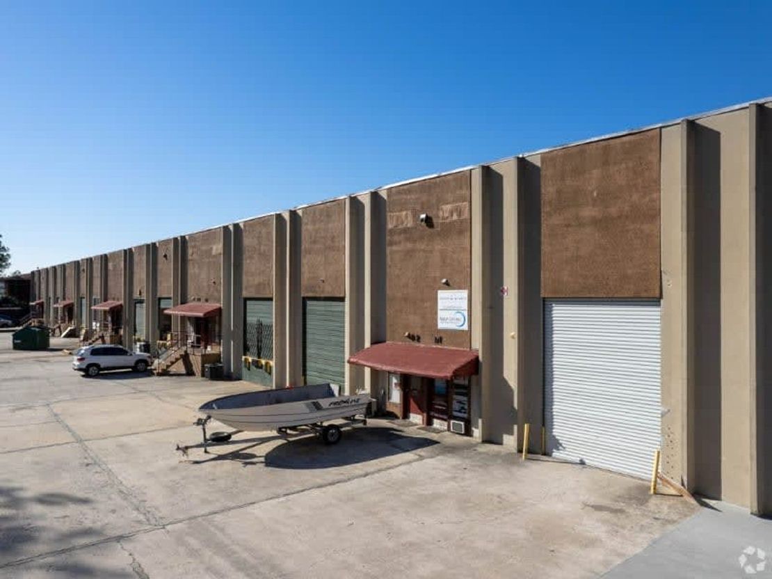 A long, low industrial building with brown and tan facade.