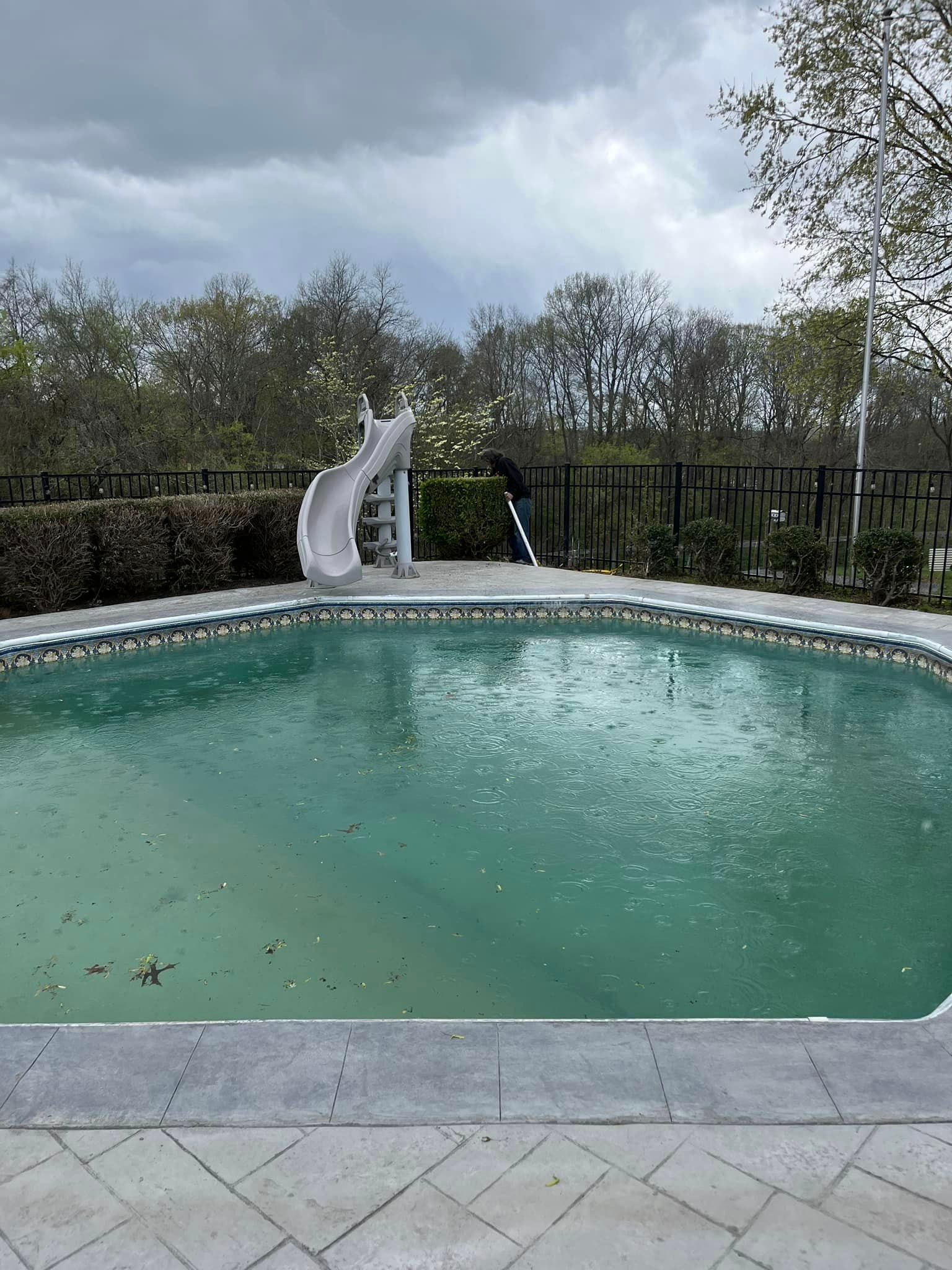 There is a slide in the middle of the pool.