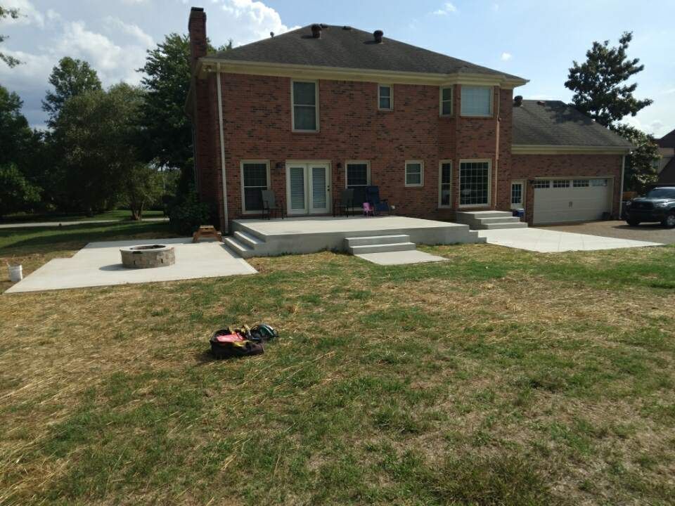 A large brick house with a large lawn in front of it
