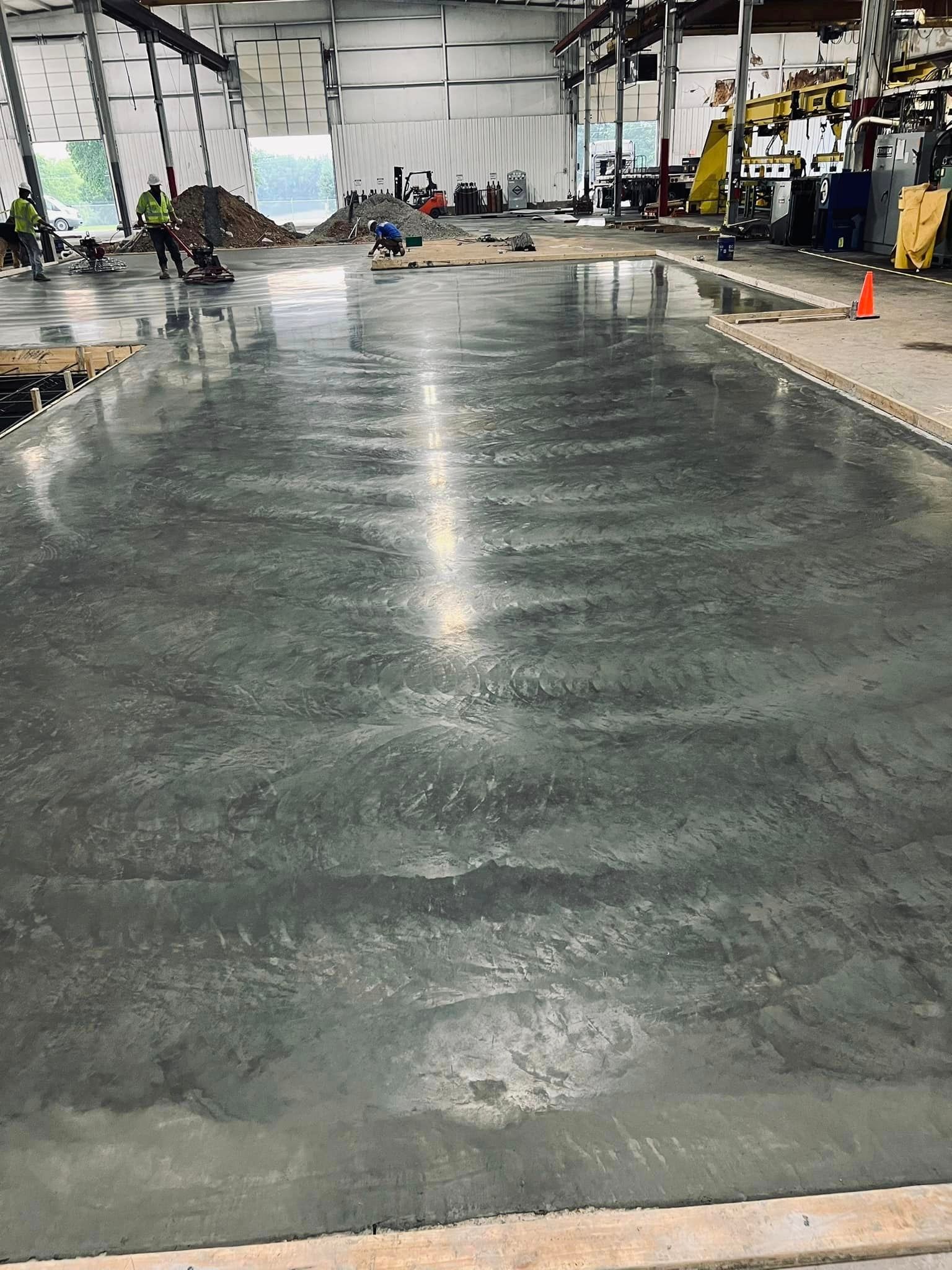 A large concrete floor in a building under construction.