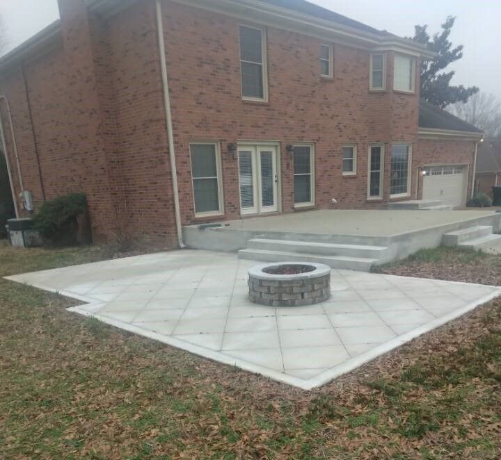 A brick house with a fire pit in front of it.