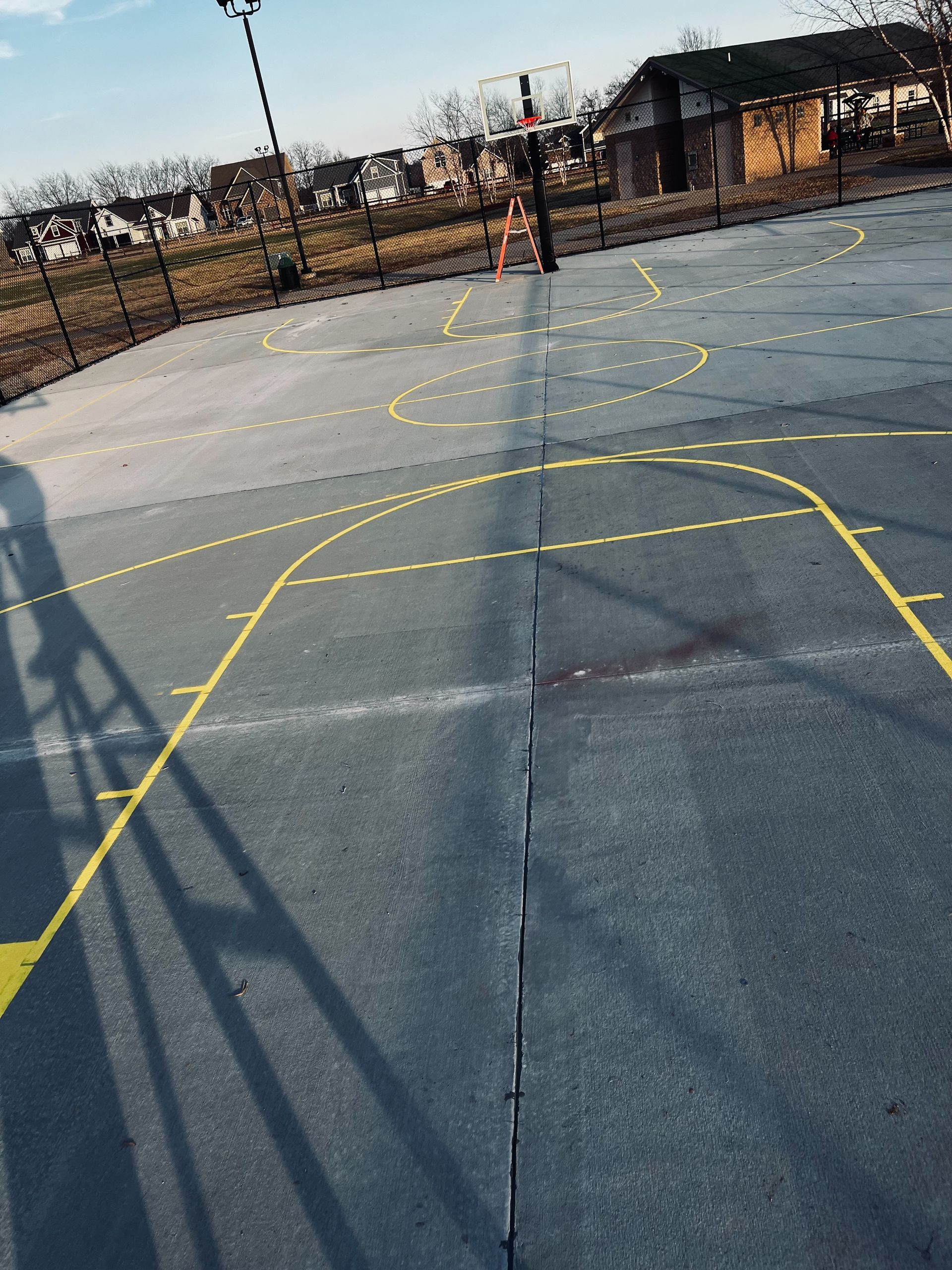 A basketball court with a shadow of a person on it