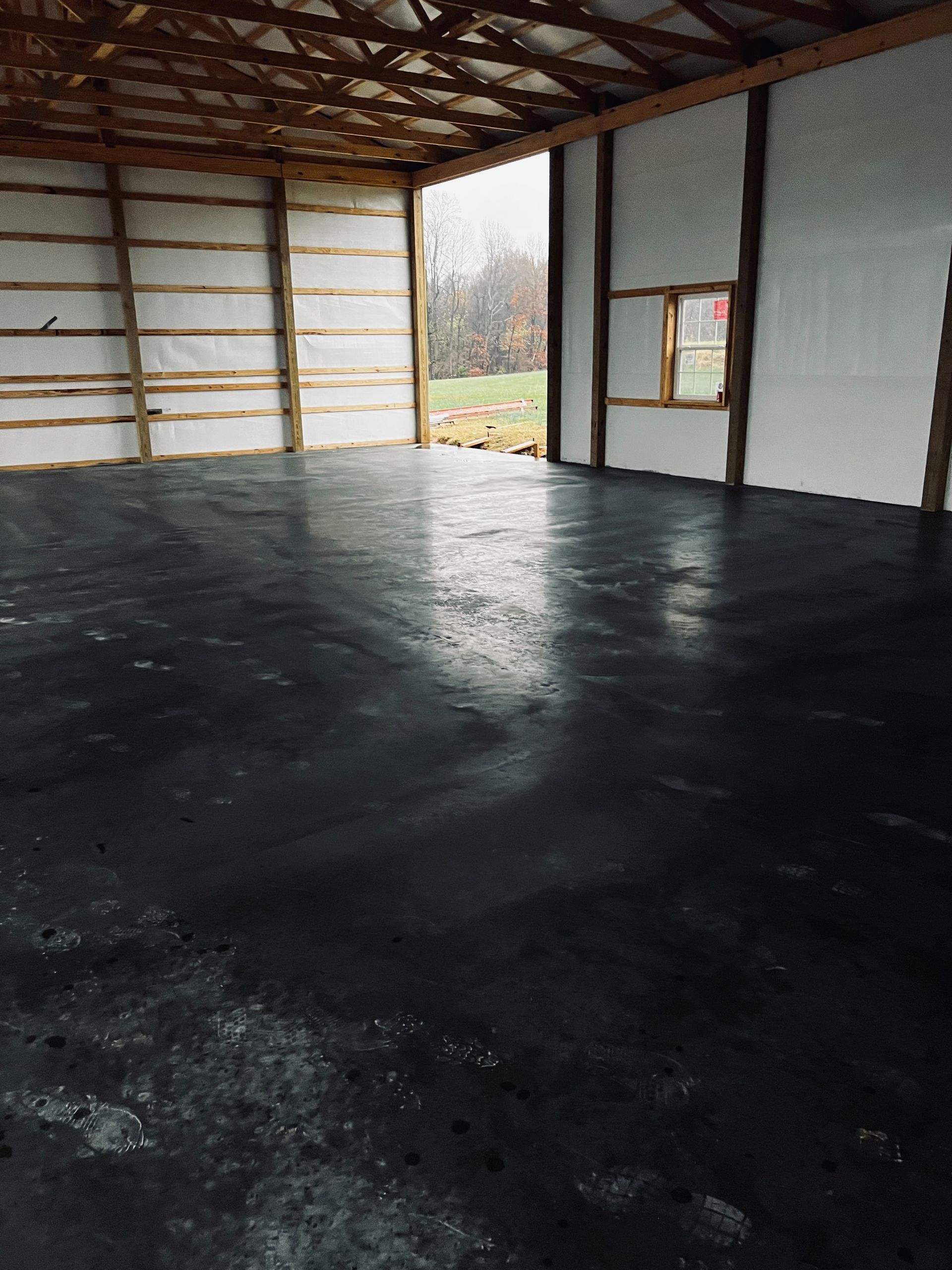 The inside of a building with a black floor and white walls.