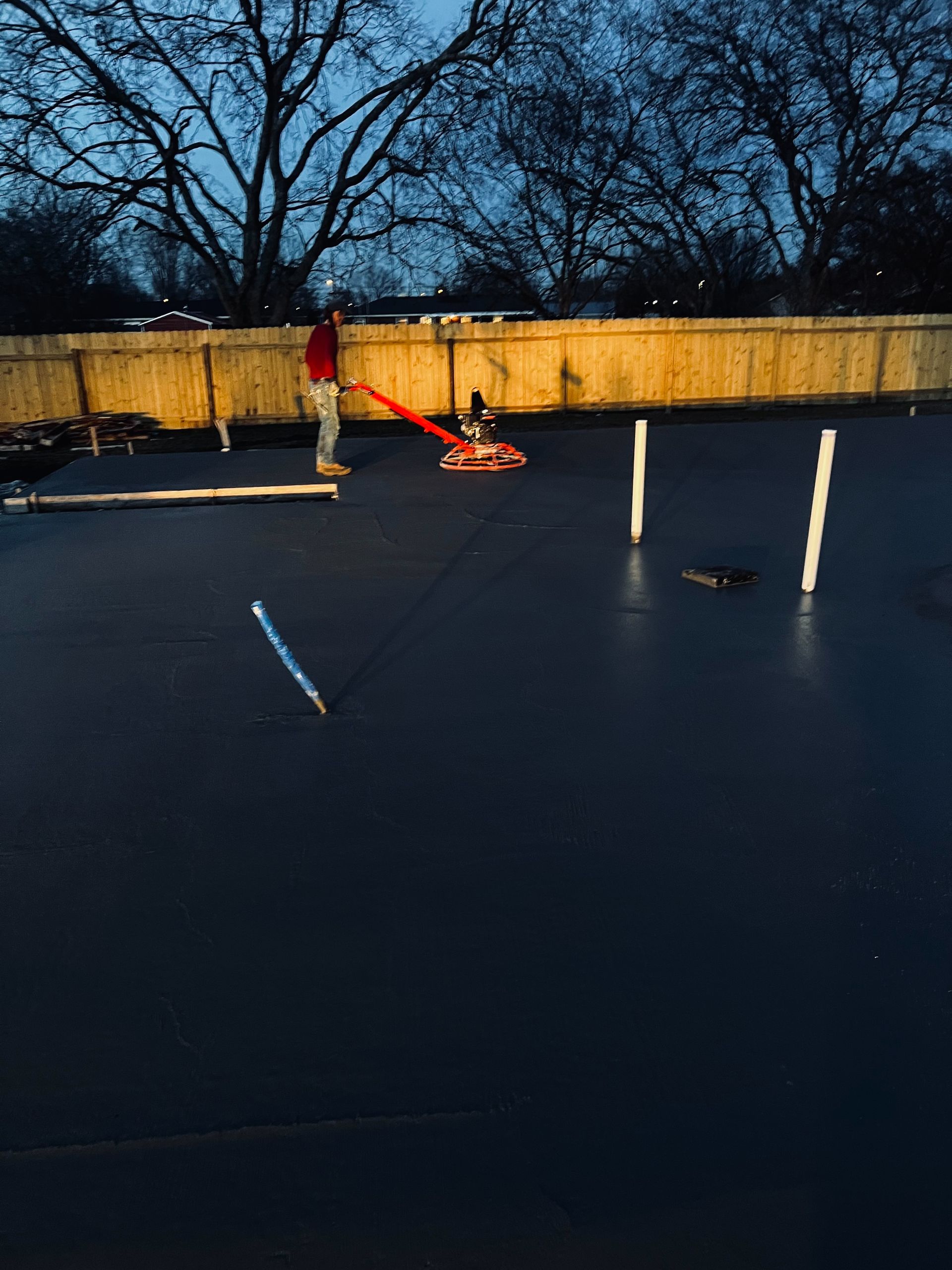 A man is pushing a machine on a concrete surface