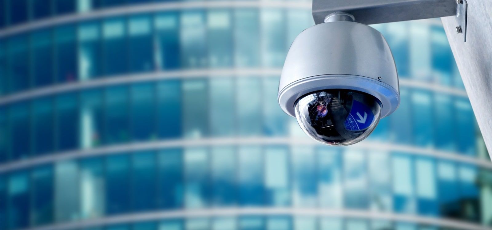 Security Camera Mounted Outside a Building With Glass Windows — NQ Video Surveillance in Bungalow, QLD