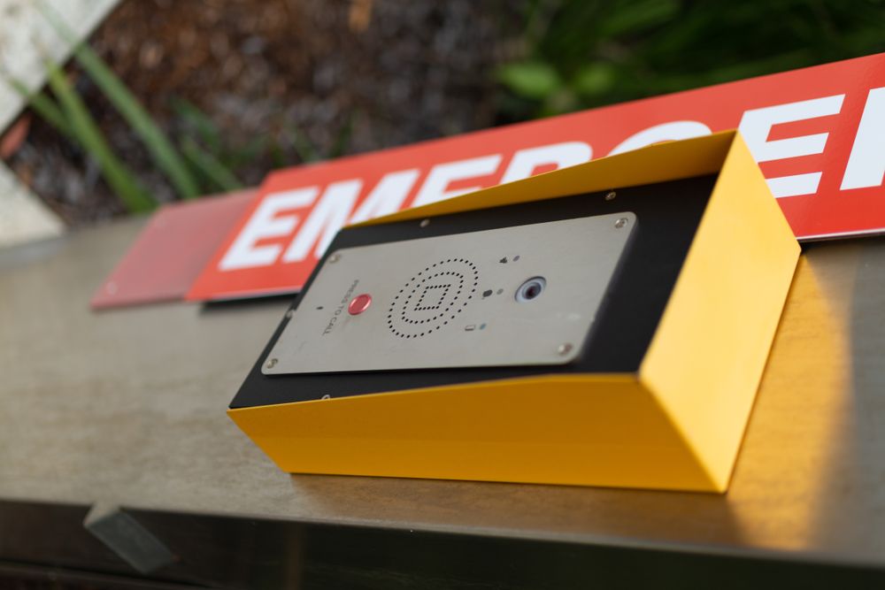 Yellow Emergency Call Box With a Red Button — NQ Video Surveillance in Bungalow, QLD