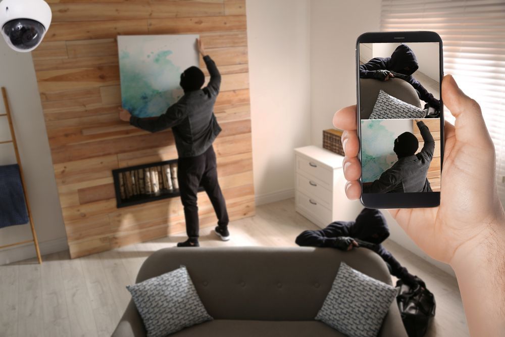 A Person Hanging a Painting While Being Seen by a Security Camera — NQ Video Surveillance in Bungalow, QLD