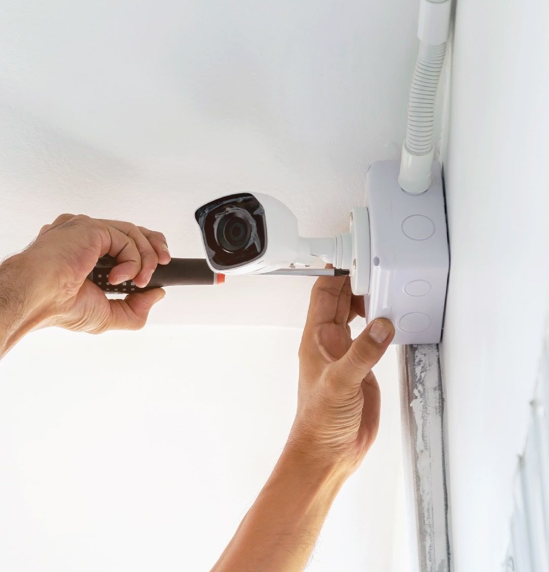 Person Using a Tool to Install a Security Camera — NQ Video Surveillance in Bungalow, QLD
