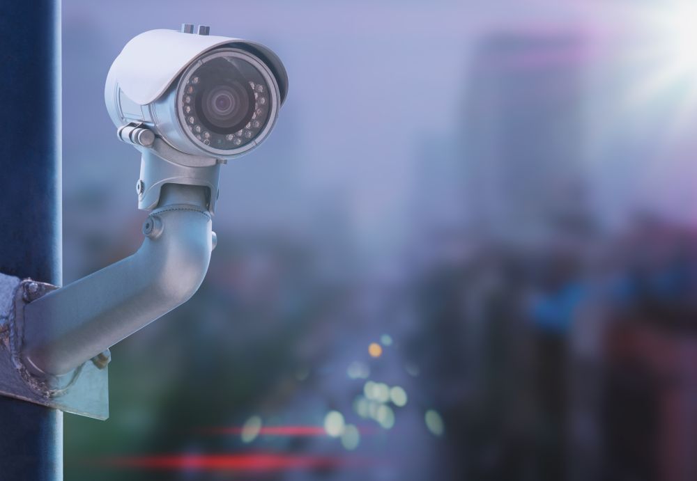 Security Camera Mounted on a Pole Overlooking a City at Dusk — NQ Video Surveillance in Townsville, QLD