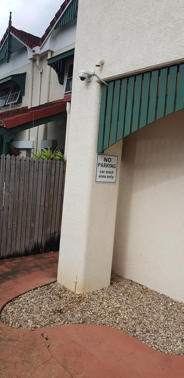 A Security Camera Mounted on a White Column Next to a Building — NQ Video Surveillance in Port Douglas, QLD