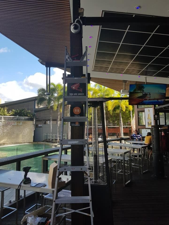 A Ladder Leans Against a Pole With a Security Camera — NQ Video Surveillance in Mt Isa, QLD