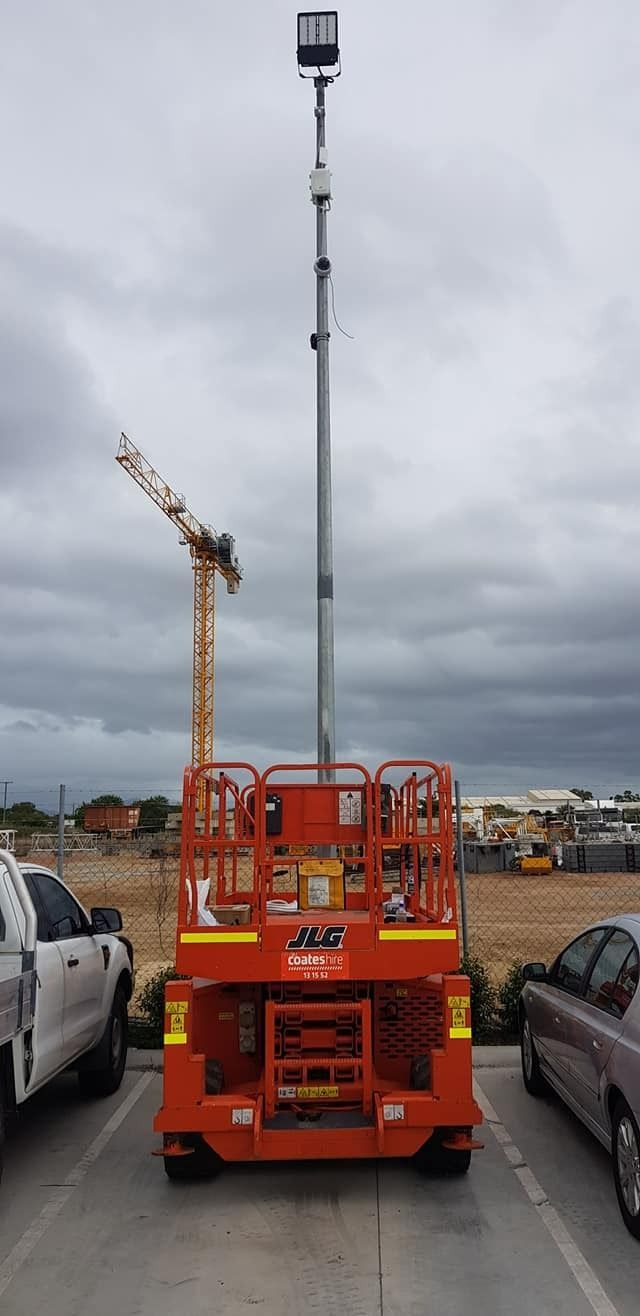 Orange Lift With a Tall Pole and Light on Top — NQ Video Surveillance in Mareeba, QLD