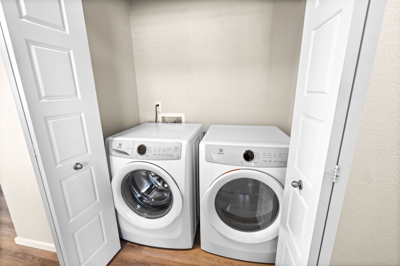Front-loading washer and dryer in a compact laundry closet.