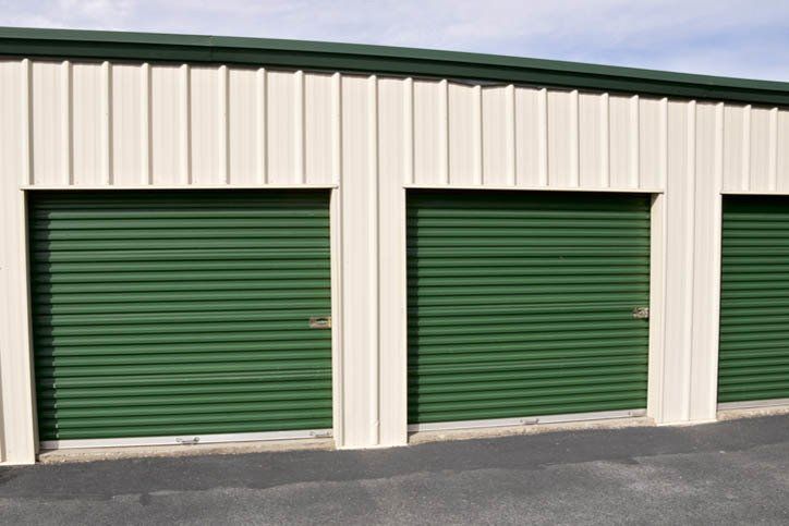 Close-up of newly built self-storage warehouse space with green doors