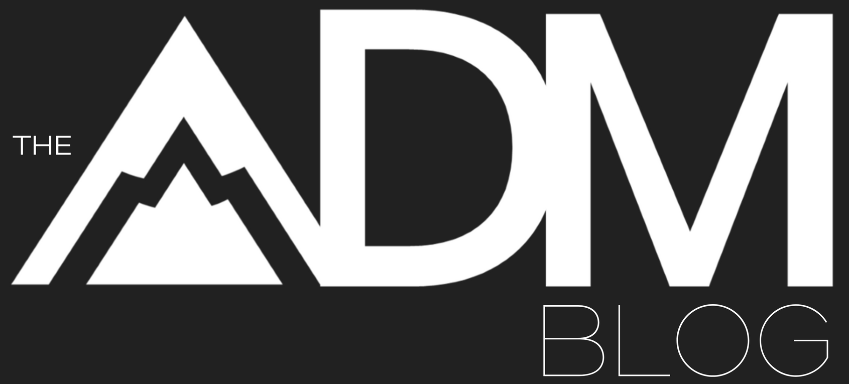 The adm blog logo is black and green with a mountain in the background.