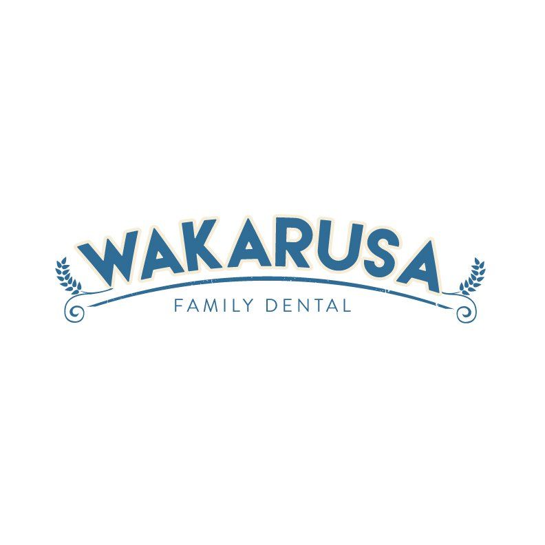 The logo for wakarusa family dental is blue and white.