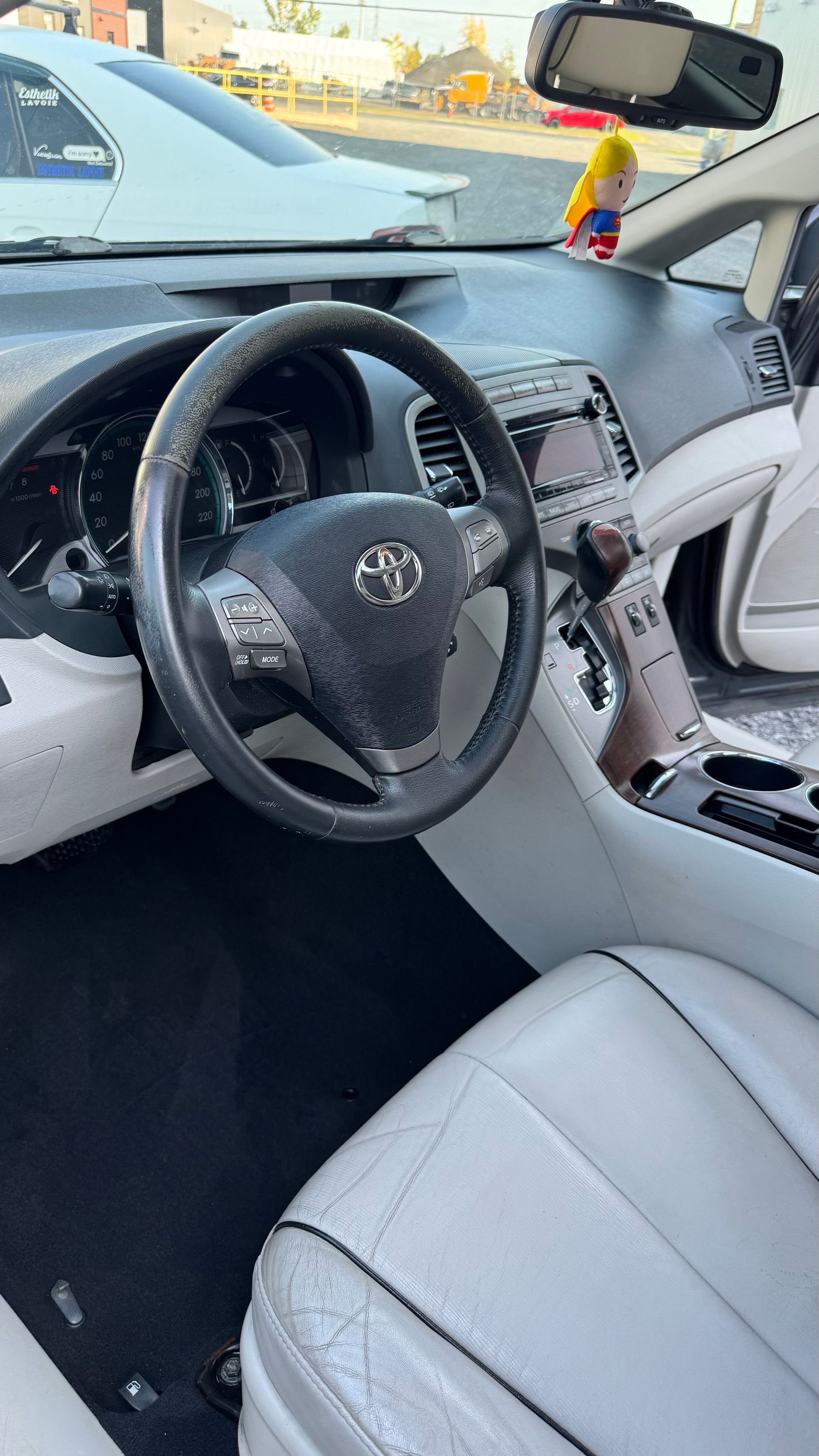 Intérieur d'une voiture. Tableau de bord, volant et sièges gris et blancs.