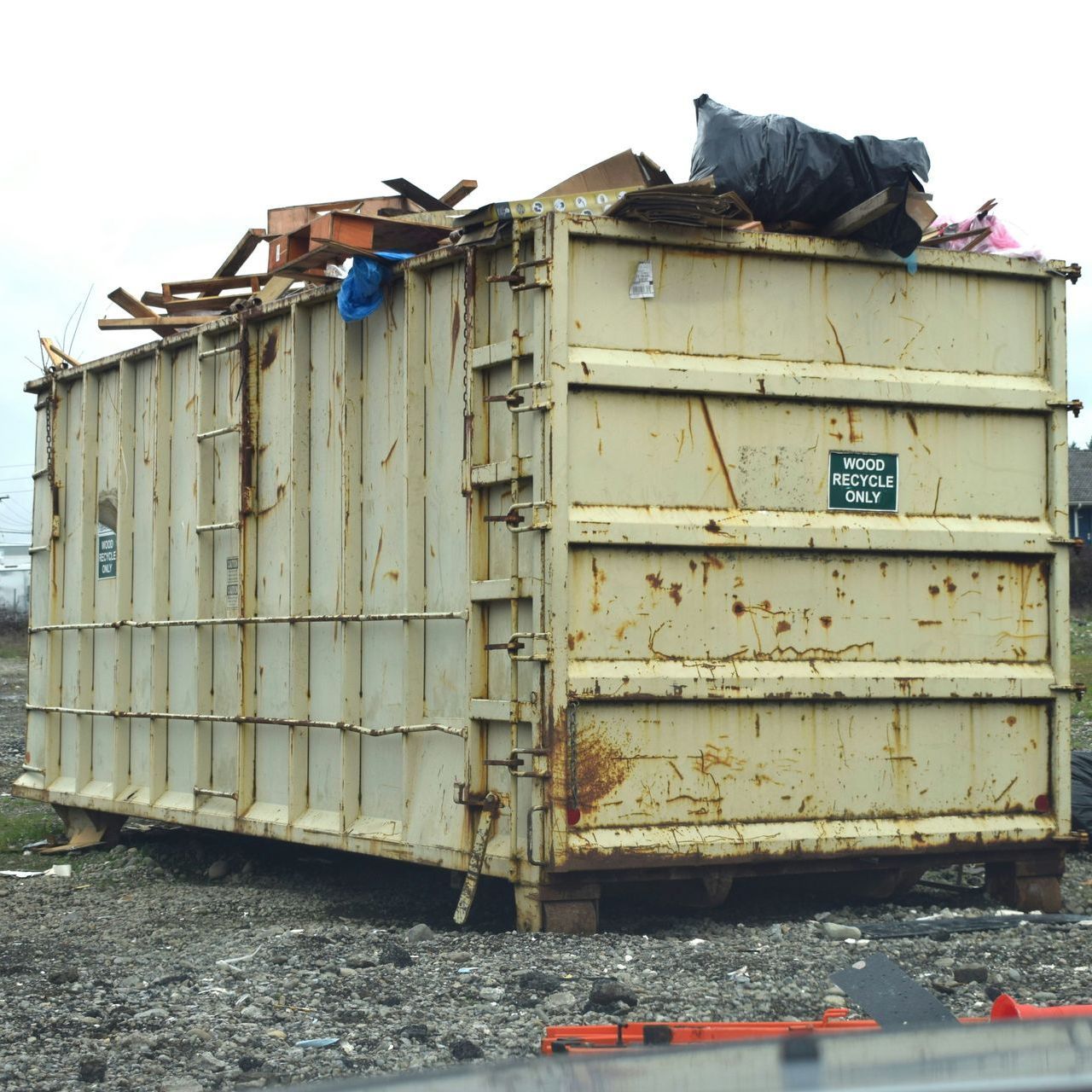 A large dumpster with a sign that says ' waste management ' on it