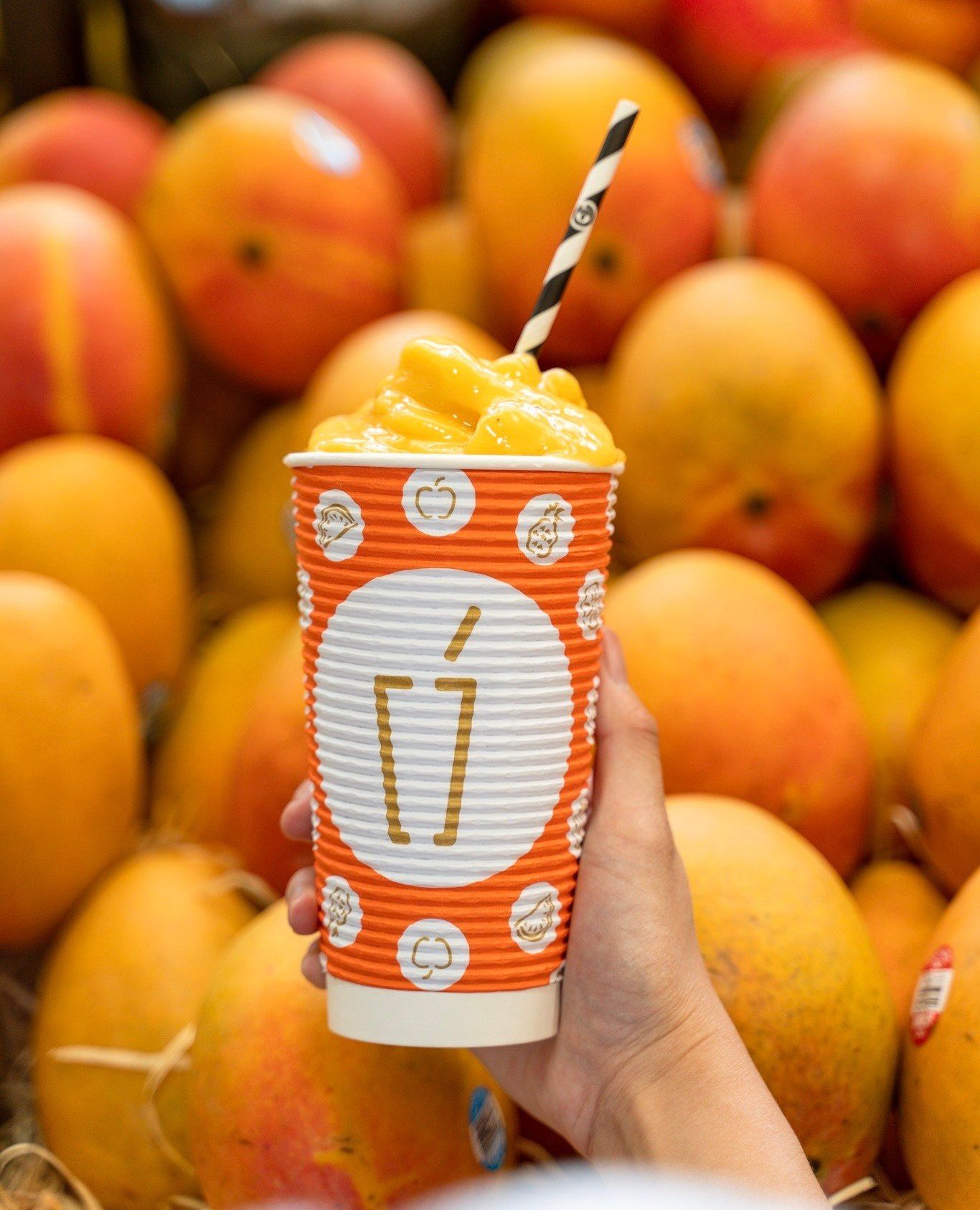 Hand Holding Thick Orange Smoothie — Quench Juice Bar in Fortitude Valley, QLD