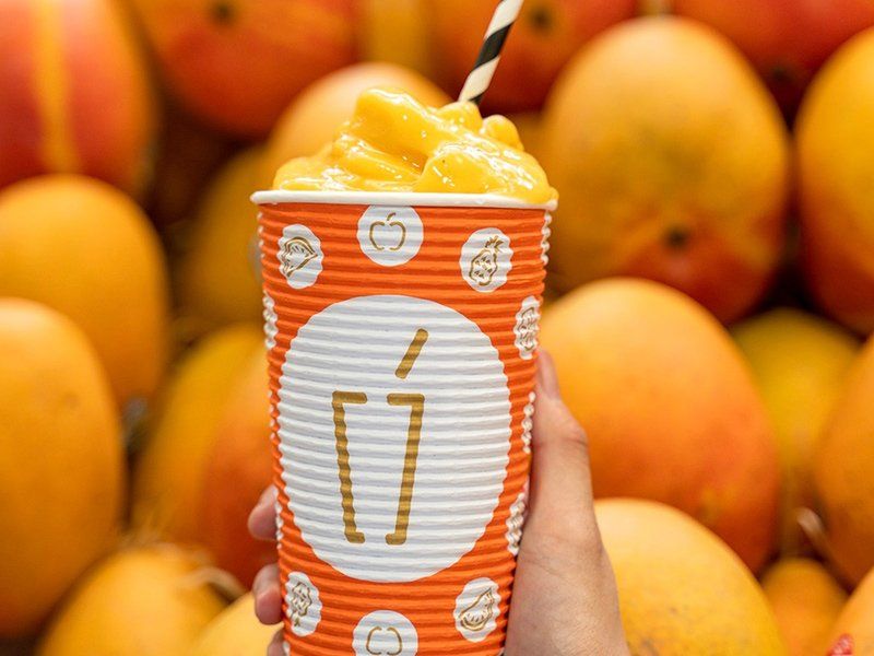 Hand Holding Orange Smoothie — Quench Juice Bar in Fortitude Valley, QLD