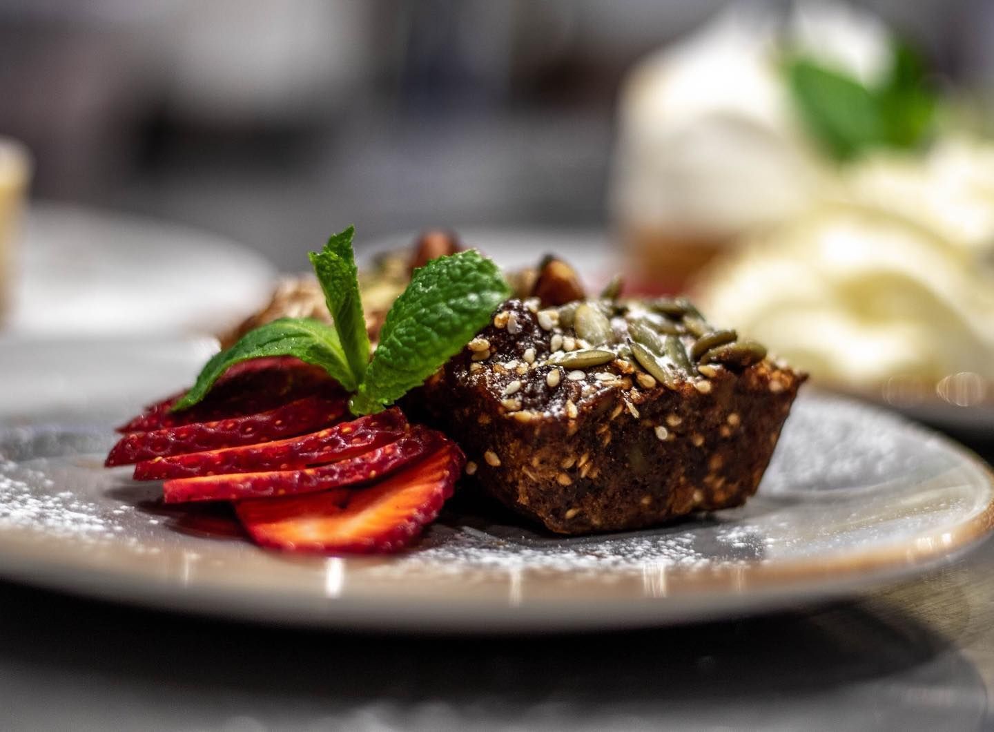 A Close Up of a Dessert With Strawberries and Mint on a Plate — Barbosa Fine Food Deli in Robina, QLD