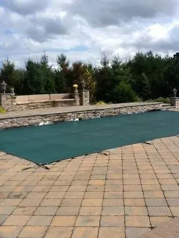 An aerial view of a swimming pool with chairs around it.