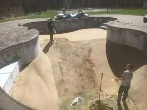 A group of people are working on a skate park.