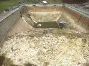 A man is working on the bottom of a swimming pool.