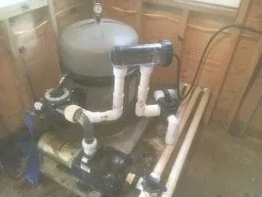 A swimming pool pump is sitting on top of a wooden table.