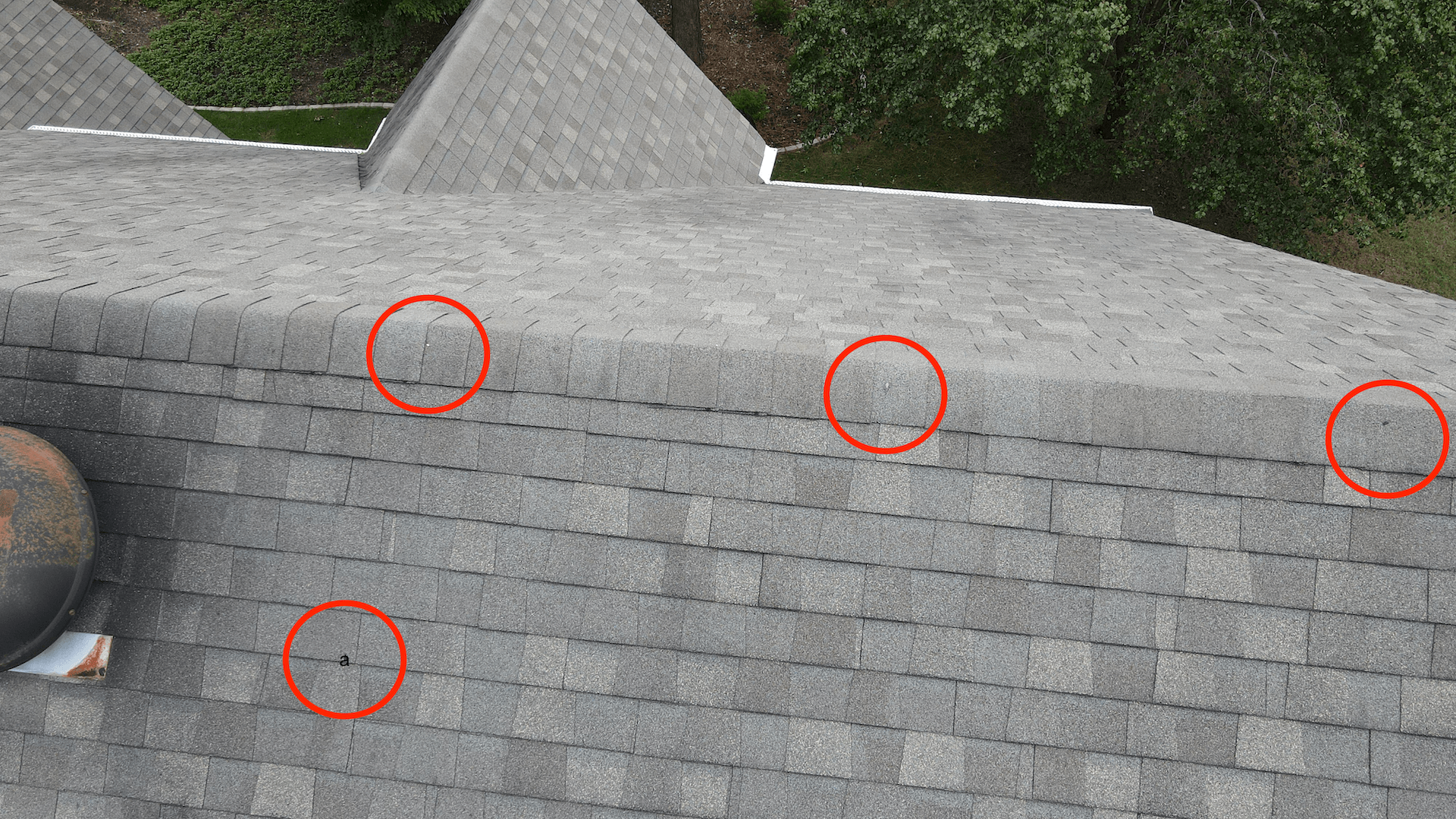 Image of a Moseley VA 23120 roof damaged by hail, with circle graphics around the damaged spots.