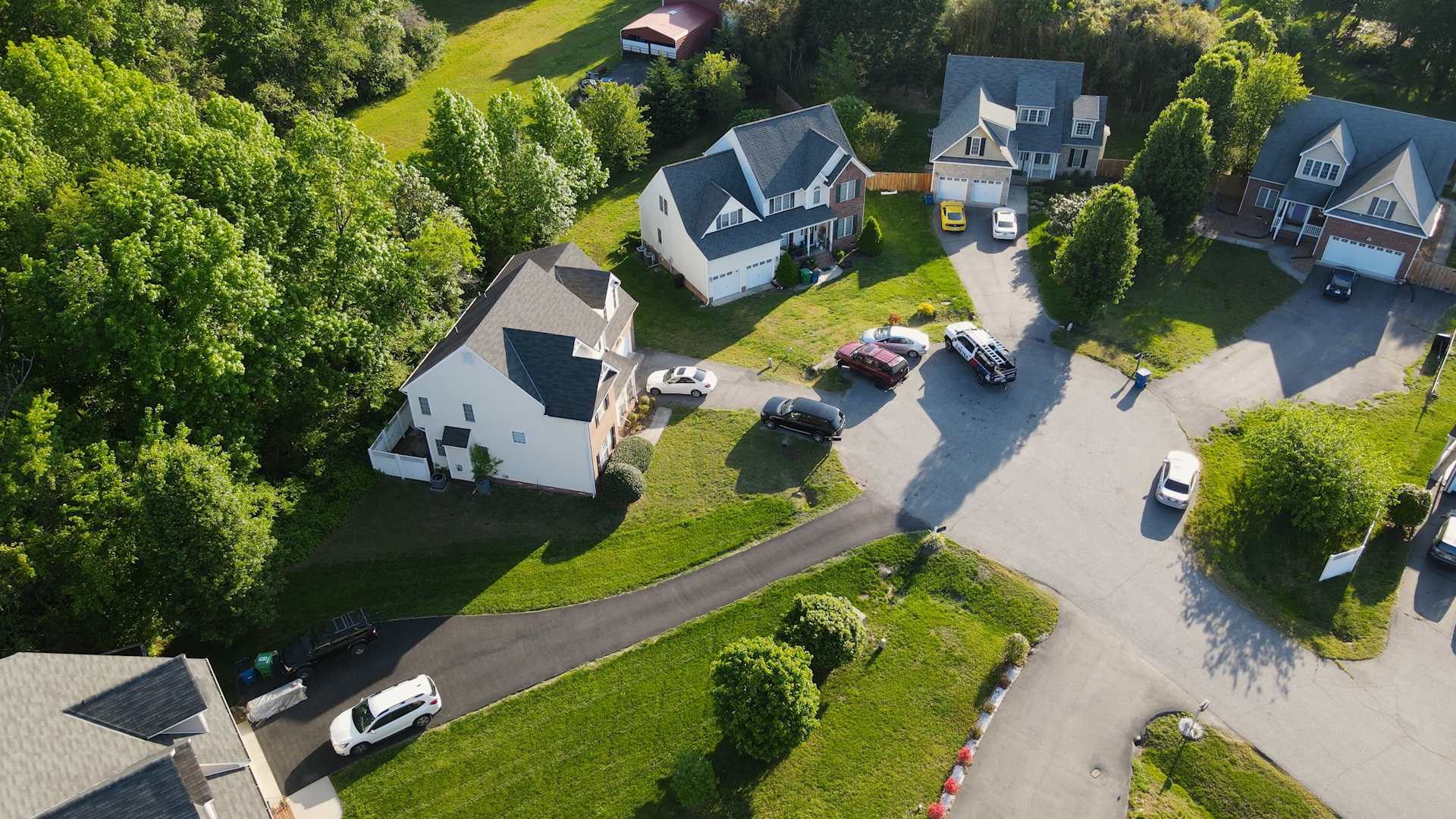 An aerial drone image of a neighborhood cul de sac. RETEX replaced the roof on the home third from the right.