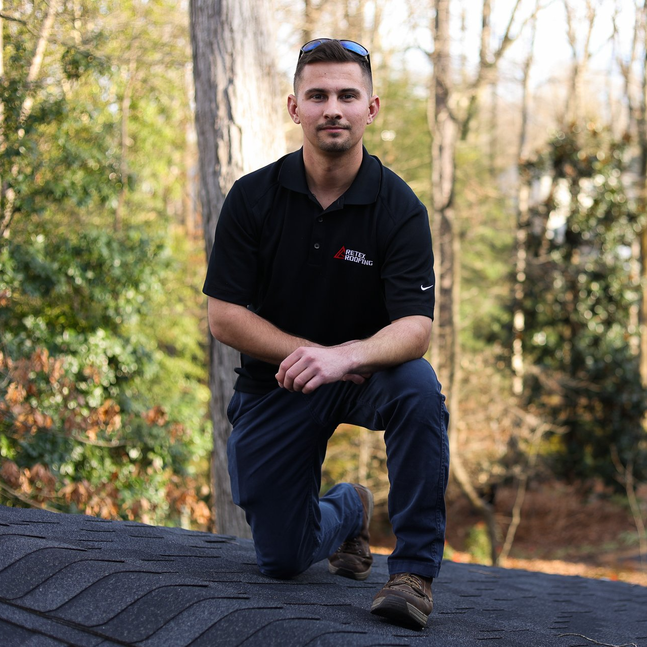 A portrait image of RETEX's Caleb Kammerling on a North Chesterfield home's roof.