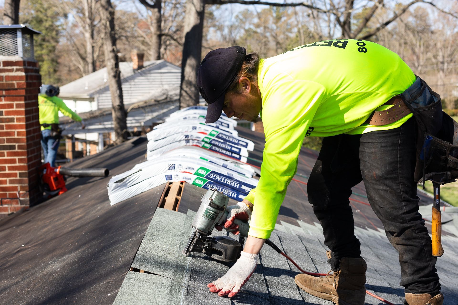Image of crew member installing asphalt shingles during roof replacement in North Chesterfield VA. By RETEX's Katelyn Lewis.
