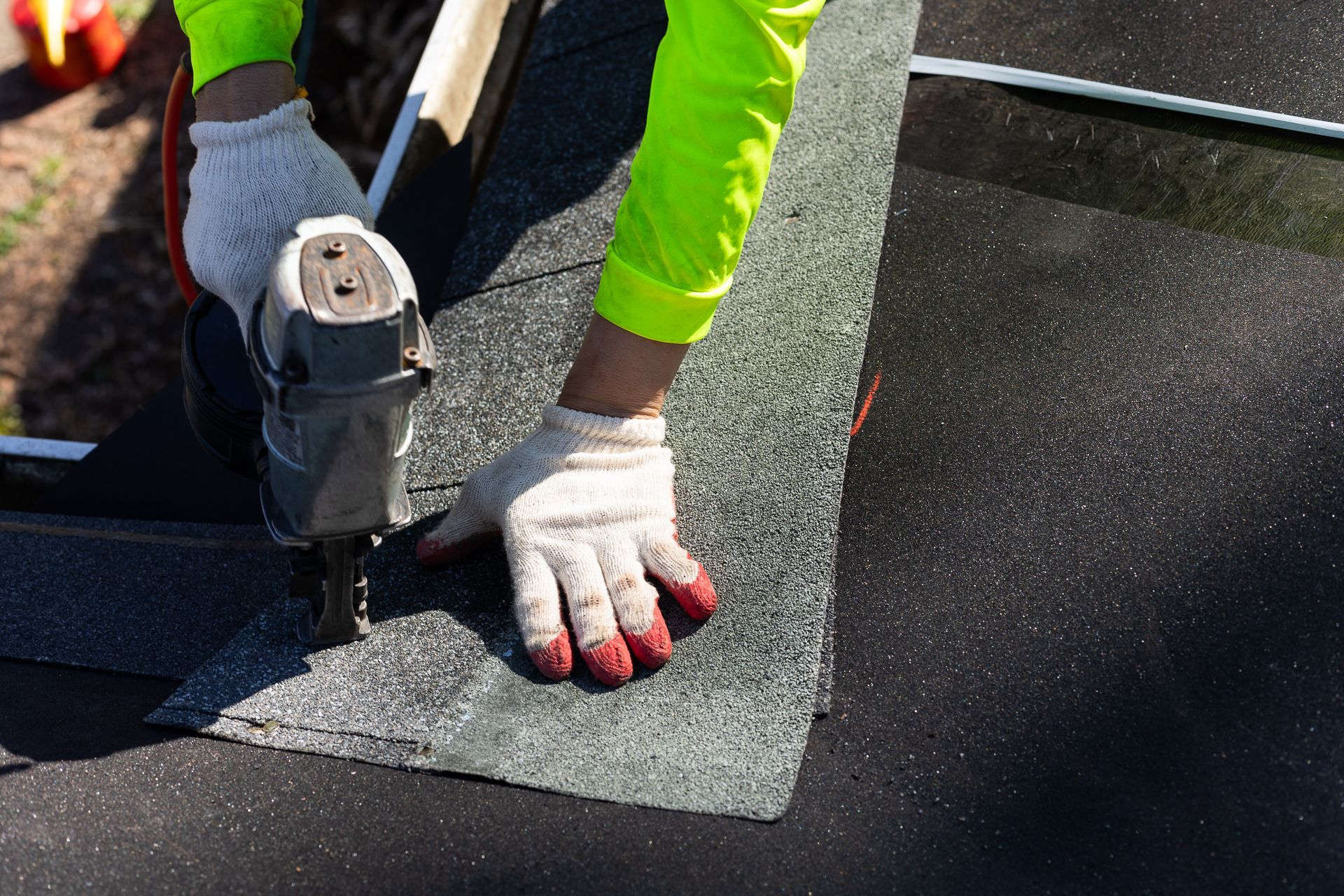 Image of crew member installing asphalt shingles during roof replacement in North Chesterfield VA. By RETEX's Katelyn Lewis.