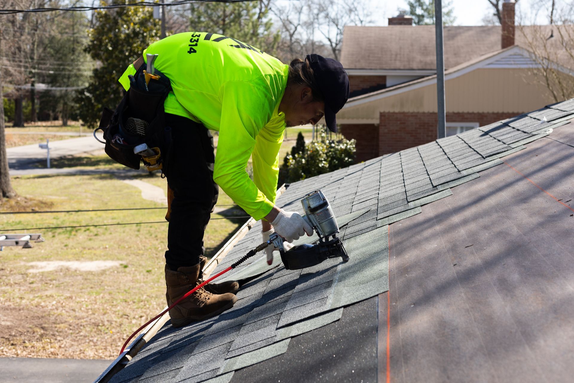 Image of crew member installing asphalt shingles during roof replacement in North Chesterfield VA. By RETEX's Katelyn Lewis.