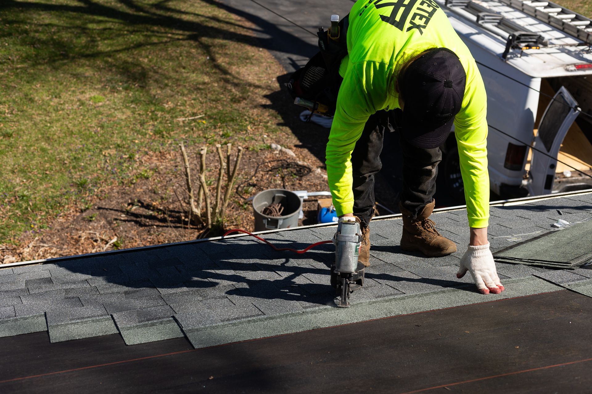 Image of crew member installing asphalt shingles during roof replacement in North Chesterfield VA. By RETEX's Katelyn Lewis.