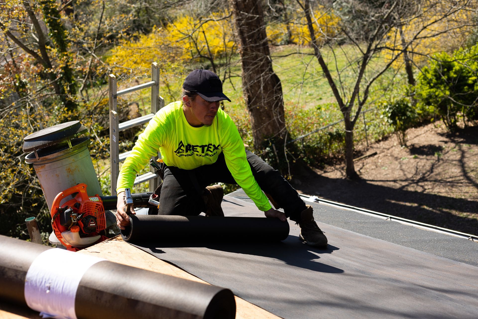 Image of crew member installing underlayment during roof replacement in North Chesterfield VA. By RETEX's Katelyn Lewis.