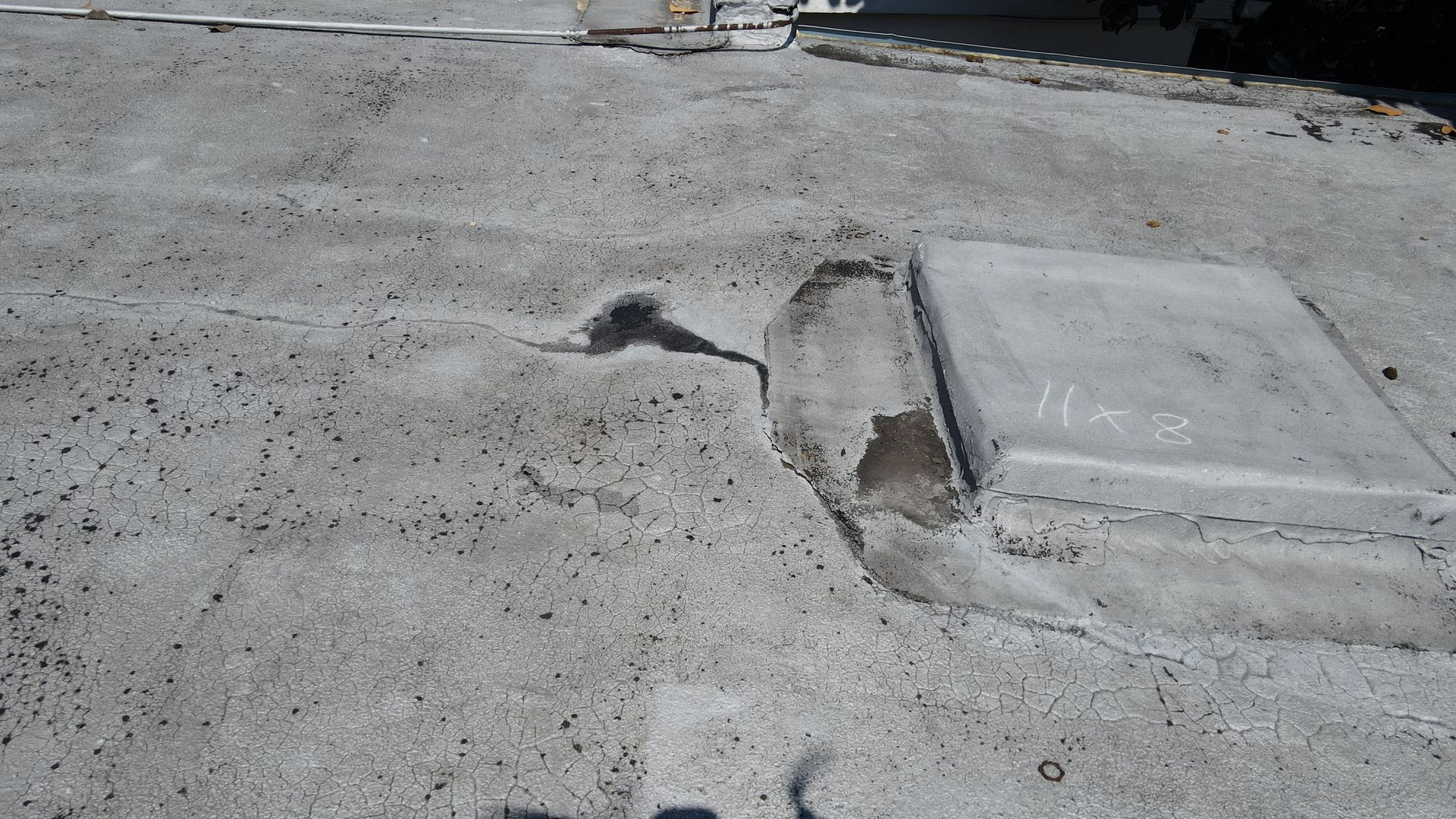 Image of damaged, old flat roof on Richmond VA home. Photo captured by RETEX's Caleb Kammerling