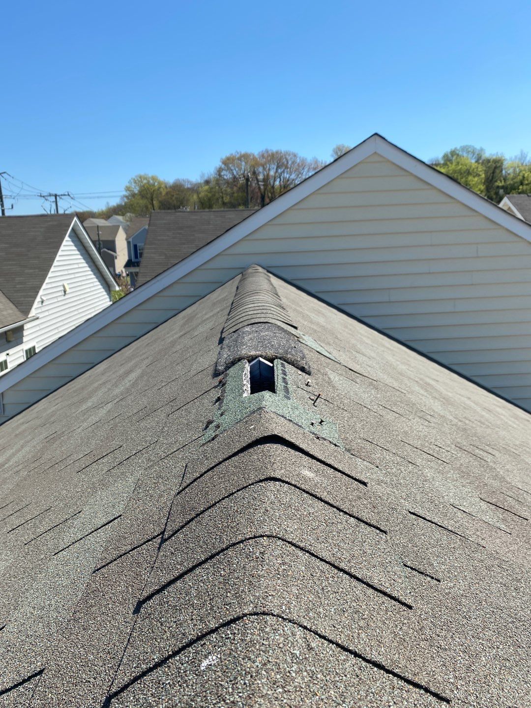 Image of damaged ridge cap on Richmond VA home.