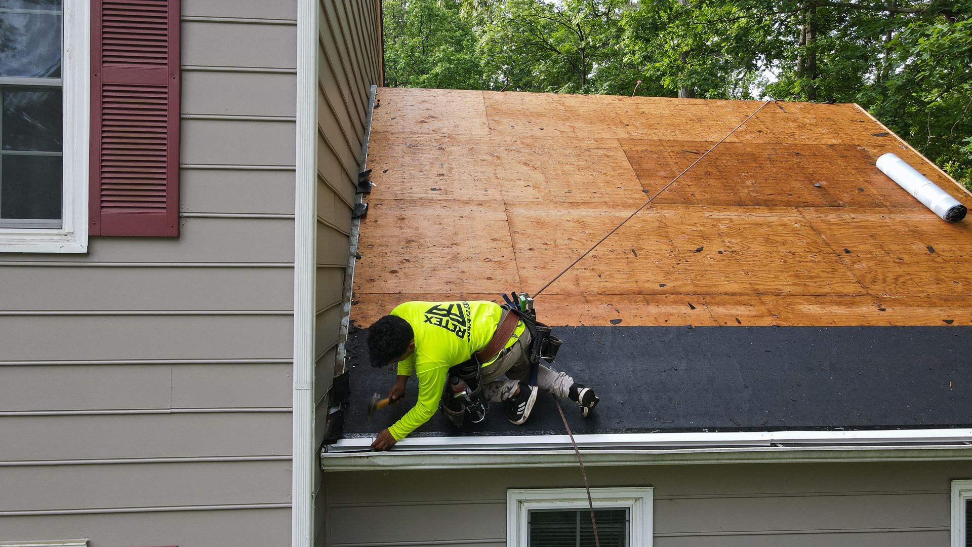 Image of a RETEX crew member installing drip edge during an asphalt shingle roof installation in North Chesterfield VA 23235.