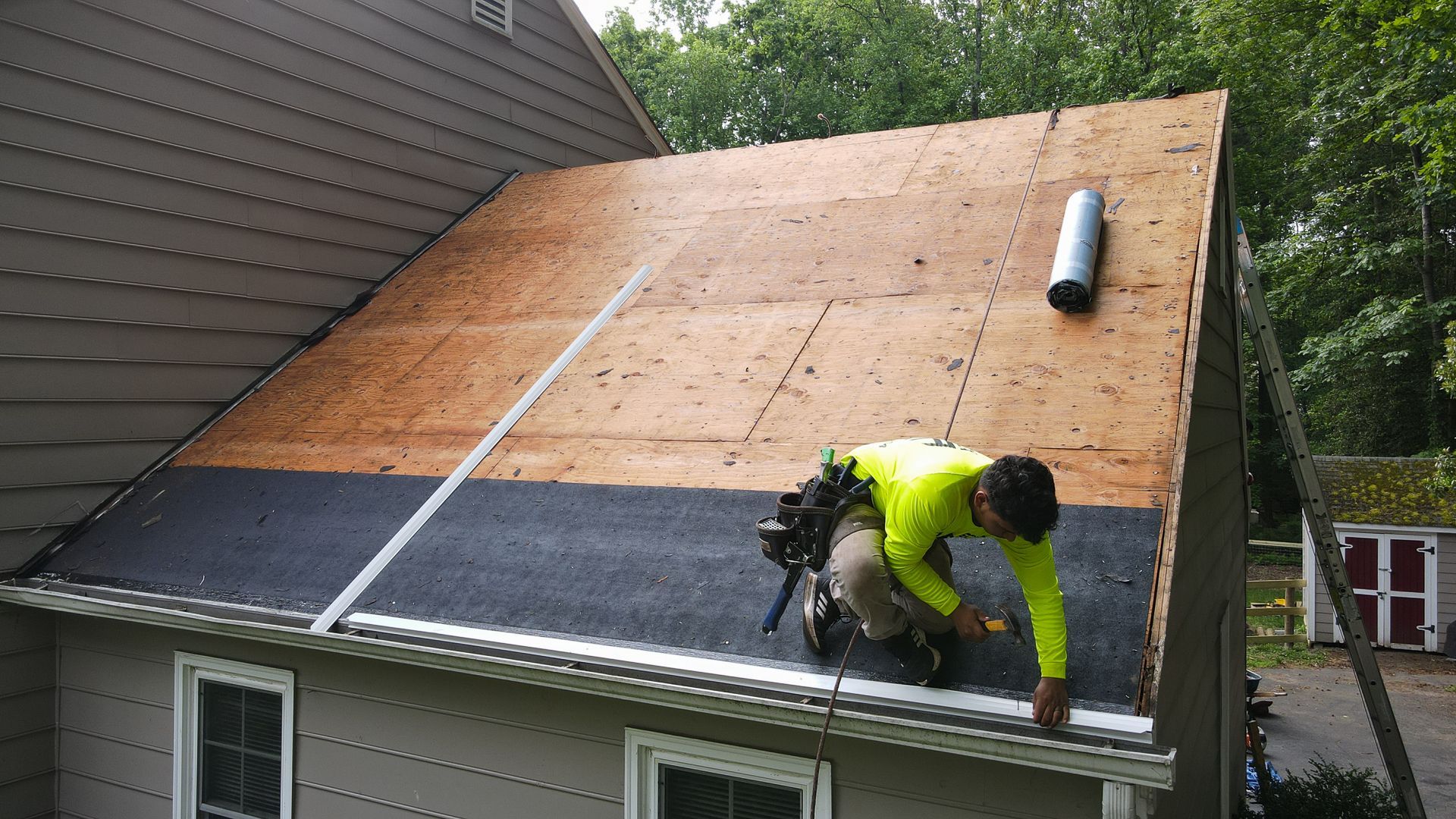 Image of a RETEX crew member installing drip edge during an asphalt shingle roof installation in North Chesterfield VA 23235.
