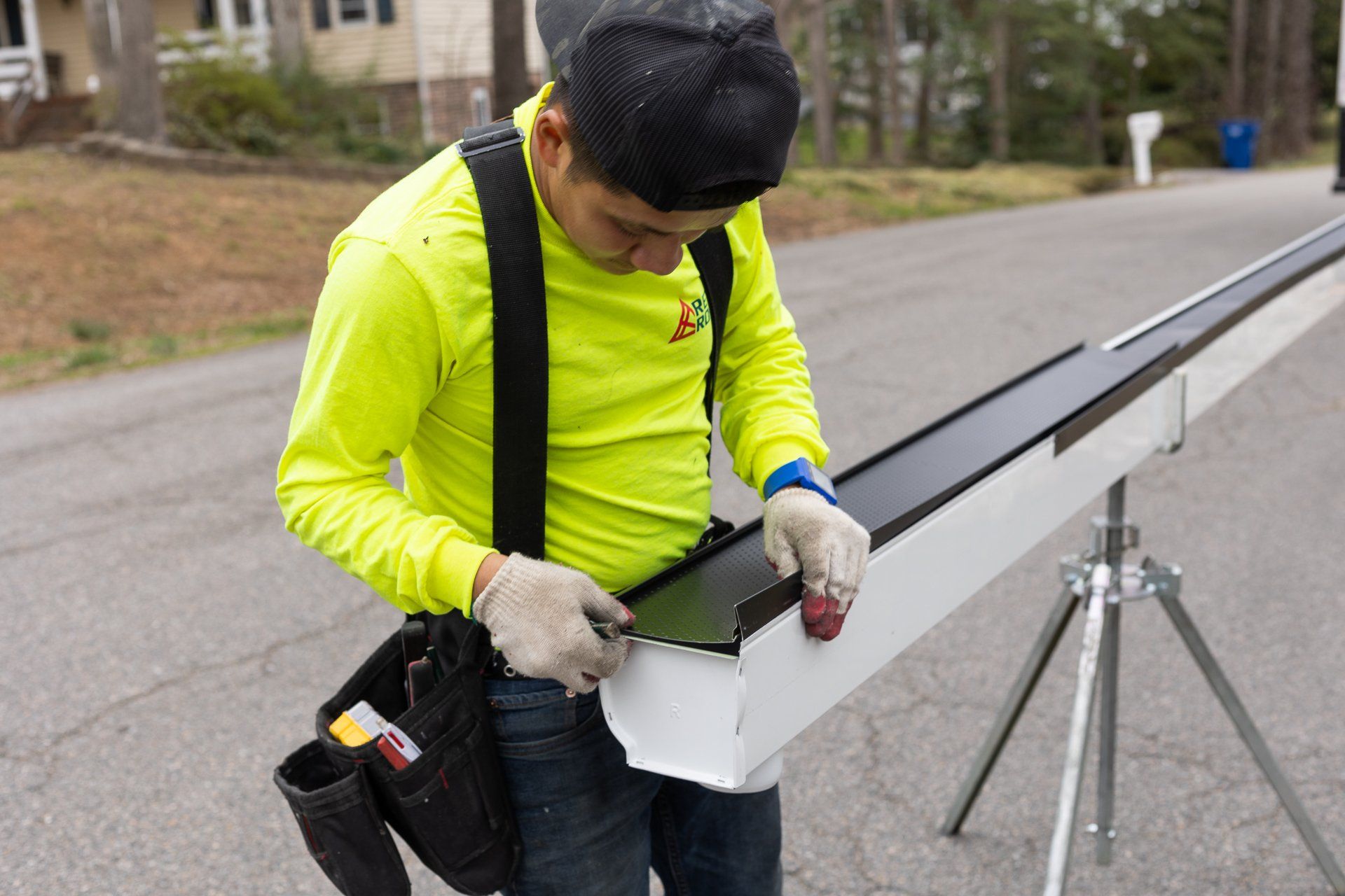 Image of a RETEX crew member installing gutter guards on a Plygem gutter system for a North Chesterfield VA home.