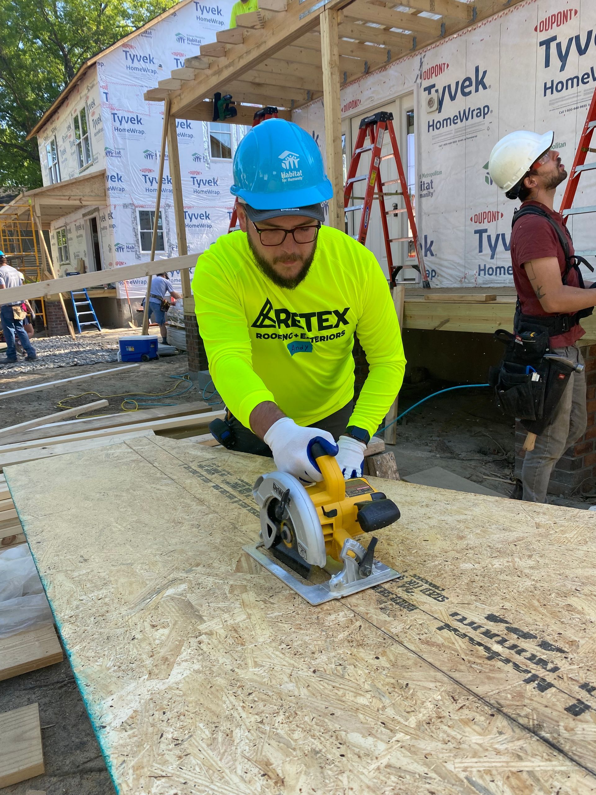 Image of RETEX’s Mark Erickson, Caleb Kammerling, Josh Lewis, and Caleb Hennon at a Richmond Habitat for Humanity job site.