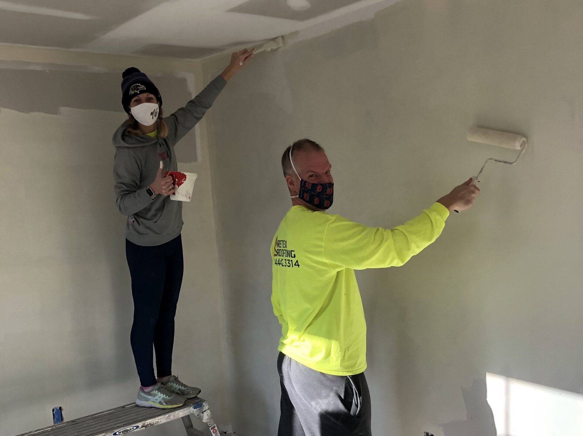Image of RETEX's Katelyn Lewis and Mark Erickson volunteering by painting at Richmond Habitat for Humanity in January 2022.