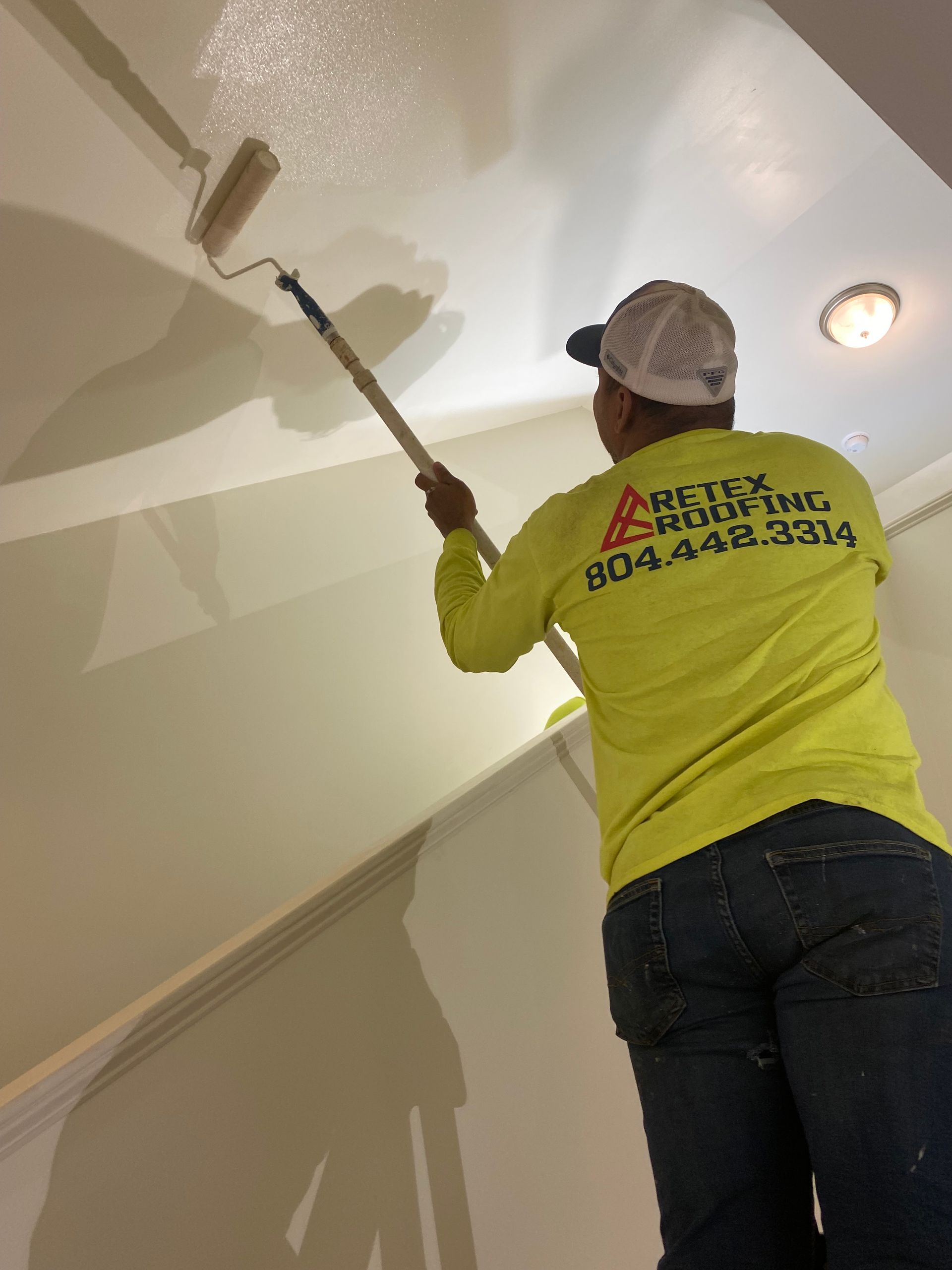 Image of RETEX's Julio Castillo-Marin volunteering by painting at Richmond Habitat for Humanity in February 2023.