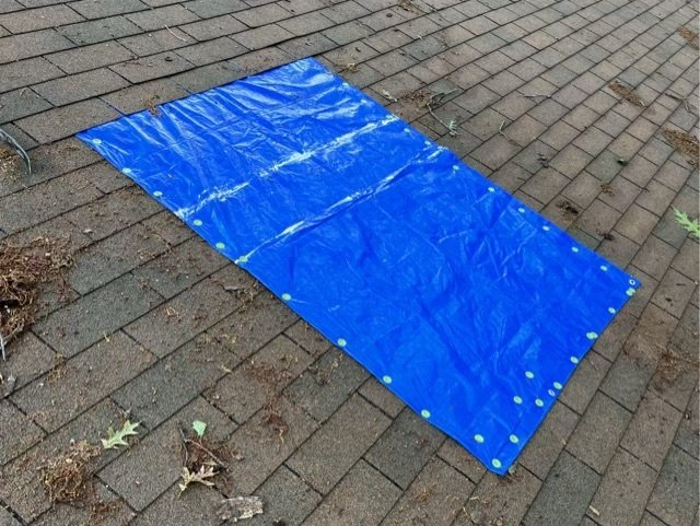 Image of a tarp over a damaged section of roof in RIchmond VA.