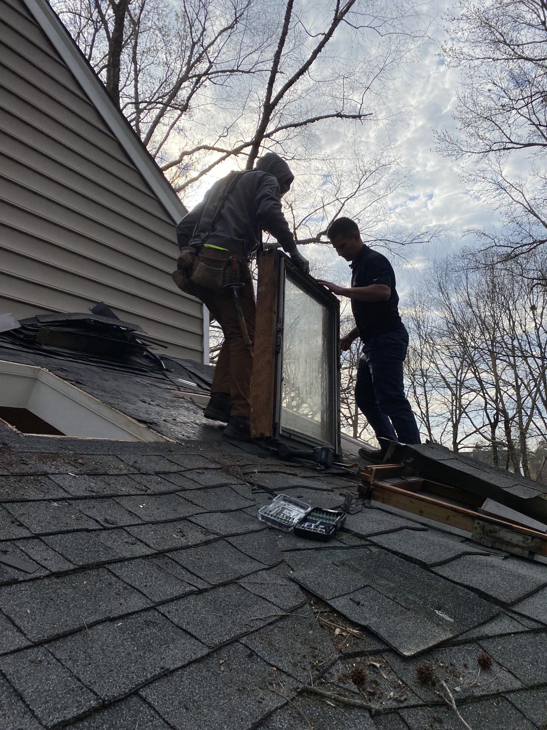 RETEX's Caleb Hennon and Caleb Kammerling install a new skylight at a North Chesterfield VA home.