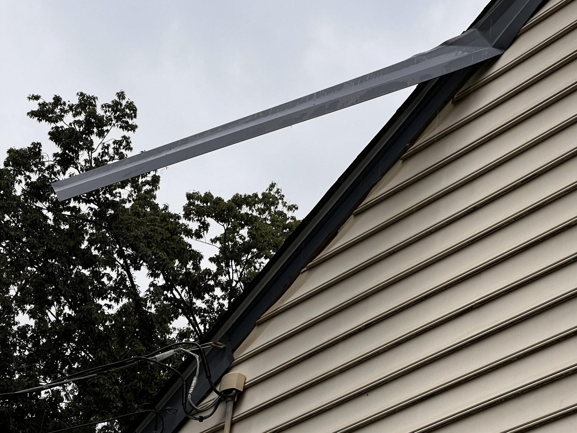 Image of aluminum trim cladding, the fascia covering, pulling away from a home.